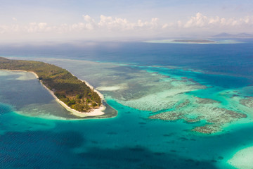 Fototapeta na wymiar Canabungan Island with sandy beach. Tropical island with white beach on the large atoll, aerial view. Seascape, Philippine Islands.