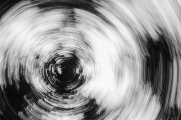 Abstract zoom circle motion blur background of the lone tree in black and white 