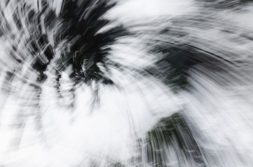 Abstract zoom circle motion blur background of the lone tree in black and white 