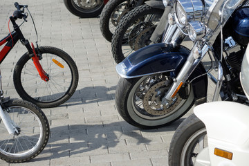 Contrasting and comparing bicycles and motorcycles in the parking lot