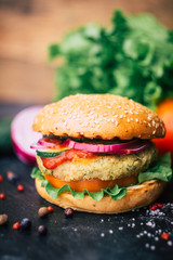 Vegetarian burger (home made burger) with chickpea cutlet and vegetables. Veg concept. Copy space.