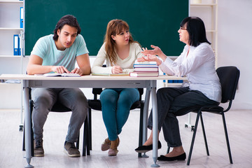 Old teacher and students in the classroom 