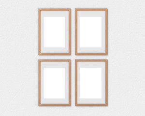 Set of 4 vertical wooden frames mockup with a border hanging on the wall. Empty base for picture or text. 3D rendering.