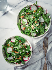 Vegan salad bowl with arugula, spinach, radish, coconut crumble or cottage cheese,walnut.Top...