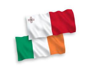 National vector fabric wave flags of Ireland and Malta isolated on white background. 1 to 2 proportion.