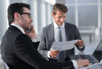 employees use a laptop to check new data.