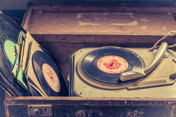 Closeup of retro gramophone with few black vinyl records