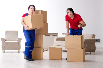 Two young contractor employees moving personal belongings