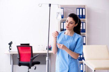 Young female doctor in infusion concept 