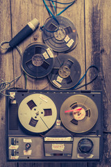 Fototapeta premium Old audio reel recorder with roll of tape and microphone