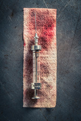 Top view of syringes with a needle on red bandage