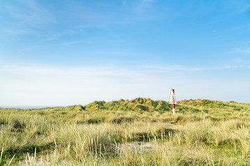 Triangular navigation sign on dune