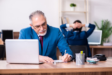 Young and old employees working together in the office 