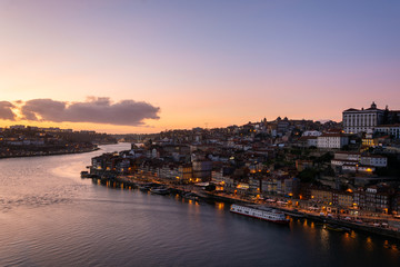 View to the city of Porto from D. Luis I bridge at sunset