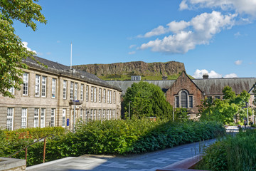 Thomson's Land, The University of Edinburgh. Holyrood park cliff in the background - Edinburgh, Scotland, United Kingdom