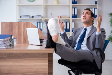 Leg injured male employee in the office 