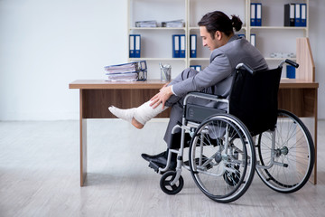 Male employee in wheel-chair in the office 