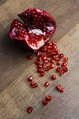 Ripe pomegranate fruit on wooden vintage background.