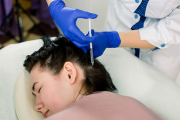 Fototapeta premium Hair loss problem, mesotherapy. Woman with hair loss problem receiving injection in beauty center, close up.