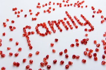 the word "family" from pomegranate seeds on a white background