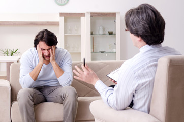Young male patient discussing with psychologist personal problem