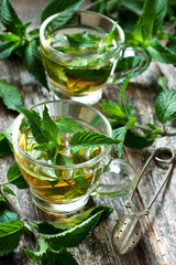 Close-up cup of mint tea with herbs