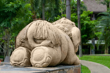 a funny little elephant, the sculpture is ass to the viewer.