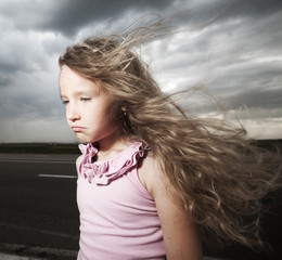 Sad child near road