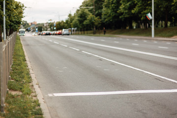 Fototapeta na wymiar urban car asphalted road in defocus, street without people, transport in the city