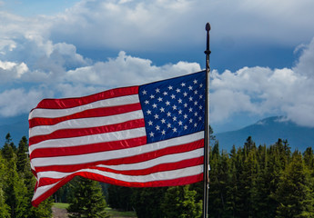 American Flag, red, white and blue, stars and stripes flying in the breeze 