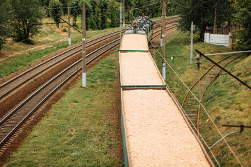 Gravel railway with freight train wagons