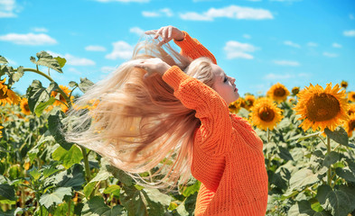 Beautiful caucasian woman posing on meadow with sunflowers.
