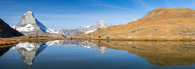 Reflection of Matterhorn peak over Riffelsee in Zermatt, Switzerland in autumn season, panorama...