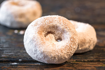 Fototapeta na wymiar Three Powdered Sugar Doughnuts