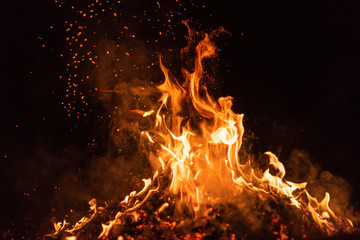 fire flames with sparks on black background - obrazy, fototapety, plakaty