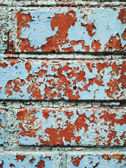 Old texture cracked red brick wall, the old blue paint texture is chipping and cracked fall destruction. Grunge wall texture for design. Cracked color background.