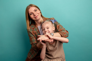 Mo and kid smiling isolated over the blue background