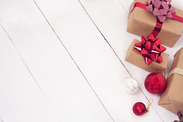 Happy new Year 2020 christmastime card. Gift boxes and christmas tree toys on background. Winter light rustic photo.