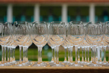A lot of wine glasses in a table