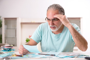 White bearded old man in budget planning concept 
