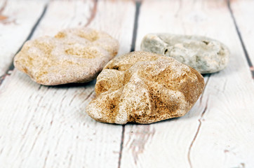 Rocks on white wooden background.