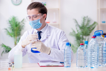Young male chemist experimenting in lab