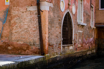 Fototapeta na wymiar Elements of architecture of houses on the streets of the canals of the city of Venice in Italy. 
