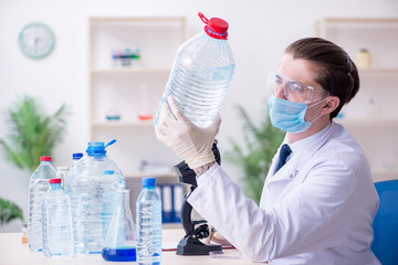 Young male chemist experimenting in lab