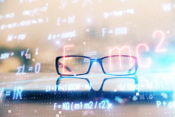 Formulas drawing with glasses on the table background. Concept of science. Double exposure.