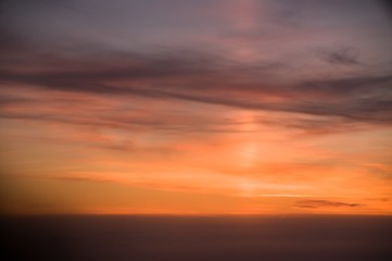 Naklejka na ściany i meble sunset in the sky. Light pillar from airplane window
