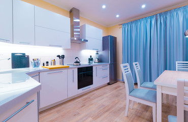 Interior. Kitchen modern, light yellow walls, blue curtains