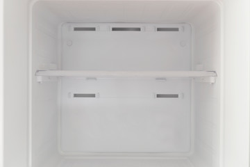 Inside the freezer compartment, the refrigerator is empty.