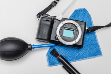 Professional digital camera service. Digital camera body and dust removal tools: brush, air blower...