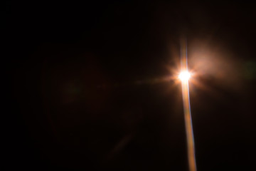 Abstract Natural Sun flare on the black background.